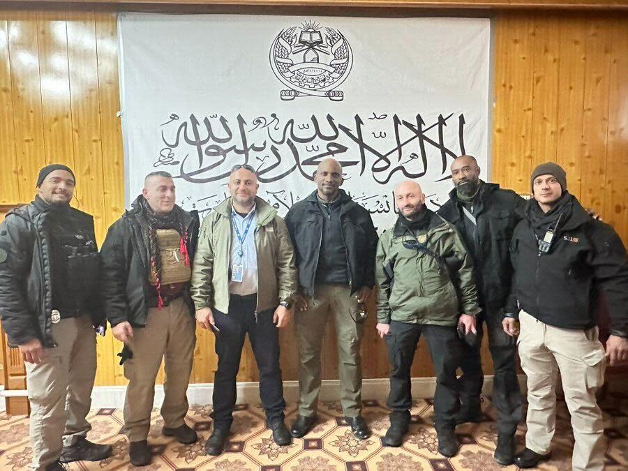 A photo shared widely on social media shows the security detail assigned to protect a senior United Nations delegation, led by Deputy Secretary-General Amina Mohammed, posing in front of a Taliban flag in Kabul, Afghanistan, during the week of January 16, 2023. The U.N. apologized for the photo, which it called 