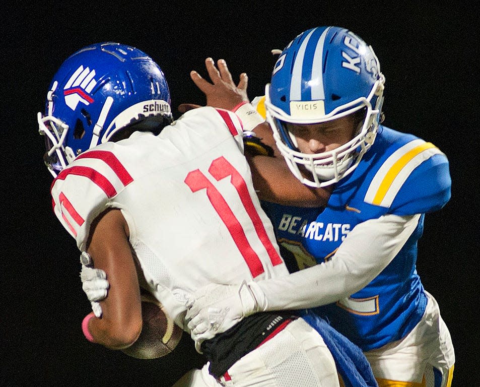 Kentucky Country Day safety Rex Rumpke has Eminence wide receiver Adonis Whitney in his grasp.Oct. 16, 2021