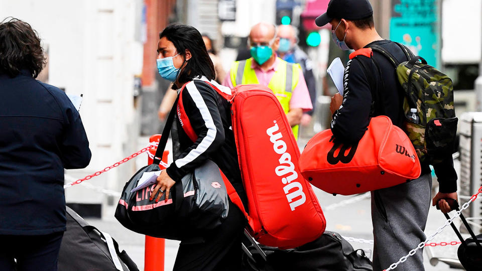 Tennis players wearing masks arrive in Melbourne from a flight ahead of the Australian Open.