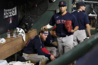 Boston Red Sox's Hansel Robles pats Alex Verdugo on the head after the team's loss to the Houston Astros in Game 6 of baseball's American League Championship Series on Friday, Oct. 22, 2021, in Houston. The Astros won 5-0, advancing to the World Series. (AP Photo/Tony Gutierrez)