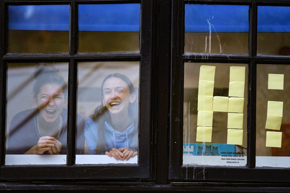 Students from Glasgow University look out of the windows of the student accommodation at Murano Street student villageGetty Images