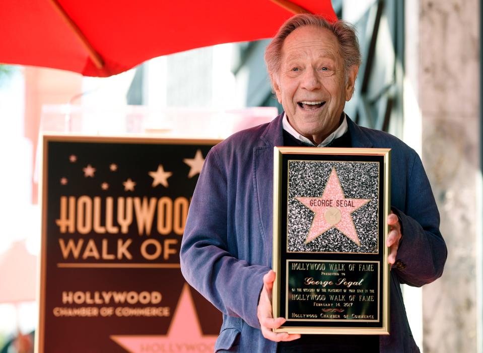 Actor George Segal poses with a replica of his new star on the Hollywood Walk of Fame on Tuesday, Feb. 14, 2017.