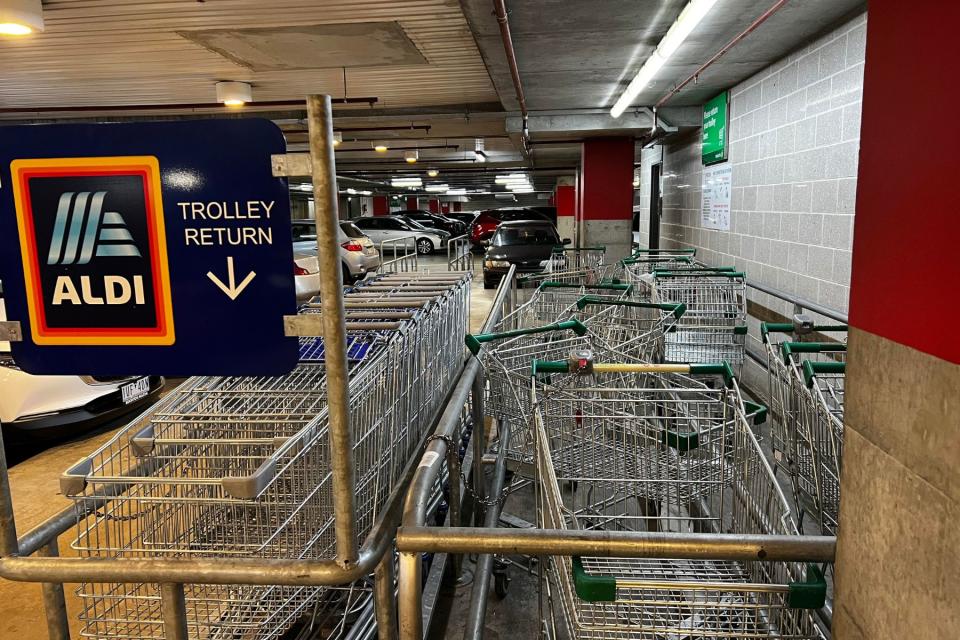  Aldi and Woolworths shopping trolleys in bay