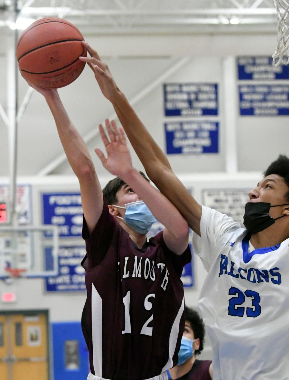 In this game from December 2021, Jack Watson of Falmouth has his shot blocked by Dantae Clarke of Mashpee.