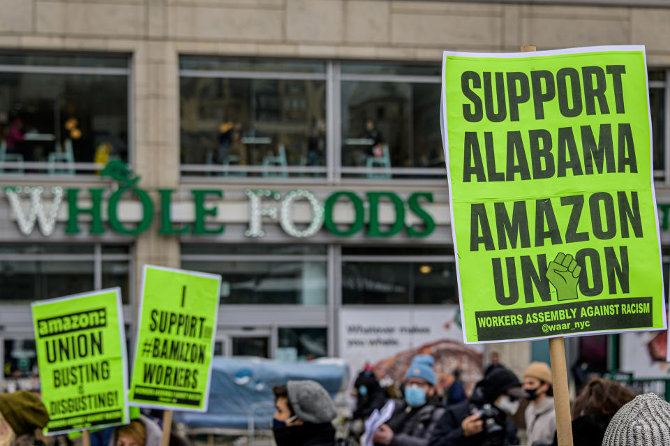 Participants seen holding signs and marching on a picket line at the protest. Members of the Workers Assembly Against Racism gathered across from Jeff Bezos-owned Whole Foods Market in Union Square South for a nation-wide solidarity event with the unionizing Amazon workers in Bessemer, Alabama.<span class="copyright">Erik McGregor—LightRocket/Getty Images</span>