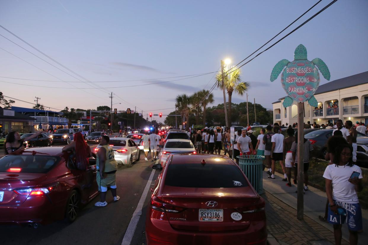 FILE - Party-goers hang out in the street during stand-still traffic caused by Orange Crush in April 2023.