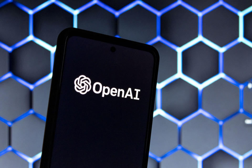 Photo illustration showing ChatGPT and OpenAI research laboratory logo and inscription at a mobile phone smartphone screen with a blurry background. Open AI is an app using artificial intelligence technology. Italy is the first European country to ban and block the robot Chat GPT application and website. ChatGPT is an artificial-intelligence (AI) chatbot developed by OpenAI and launched in November 2022 using reinforcement learning techniques both from machine and human feedback. Amsterdam, the Netherlands on April 1, 2023 (Photo by Nicolas Economou/NurPhoto via Getty Images)