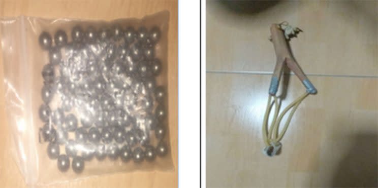 A bag of ball bearings and a catapult seized from the suspect, Tan Joo Soon Samuel, who allegedly shot pellets at two cars in Woodlands earlier this month. Photo: Singapore Police Force