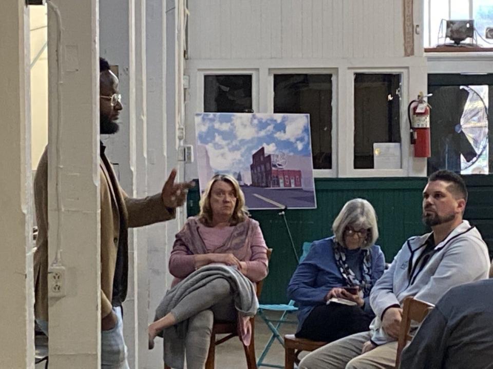 Members of the public listen as Montez Parker II presents about the Penn Street Vision Plan at Penn Market in April. Hometown History, a YouTube/podcast series exploring local history, will stream about the vision plan at 6 p.m. June 20 at Penn Market. The presentation by Hometown History’s hosts Jamie Noerpel and Dominish Marie Miller will be open to the public.