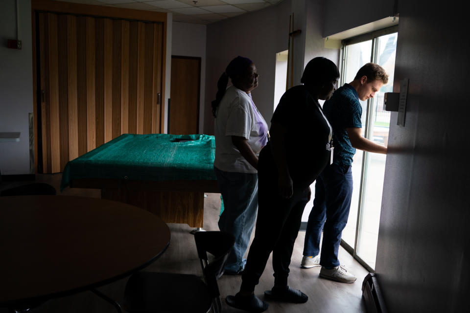 Kevin tries to open a stuck patio door at Mitchell Court. (Sarah L. Voisin/The Washington Post)