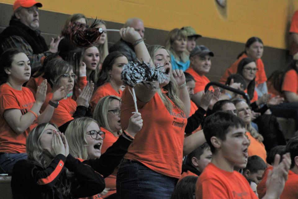 Onaway student supporters celebrate a basket during the second half on Tuesday.