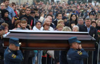 Russian Emergencies Ministry members carry a coffin during a memorial ceremony before the funeral of victims of an attack on a local college in the city of Kerch, Crimea October 19, 2018. REUTERS/Pavel Rebrov