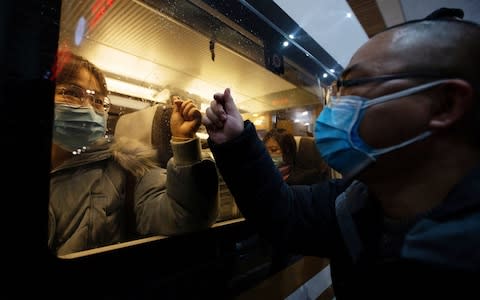 Medical teams headed to Wuhan board a train in Nanjing.  - Credit: STRINGER/EPA-EFE/REX