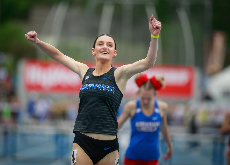 Waukee Northwest senior Mackenzie Carney celebrates after earning her school’s first individual track and field state championship.