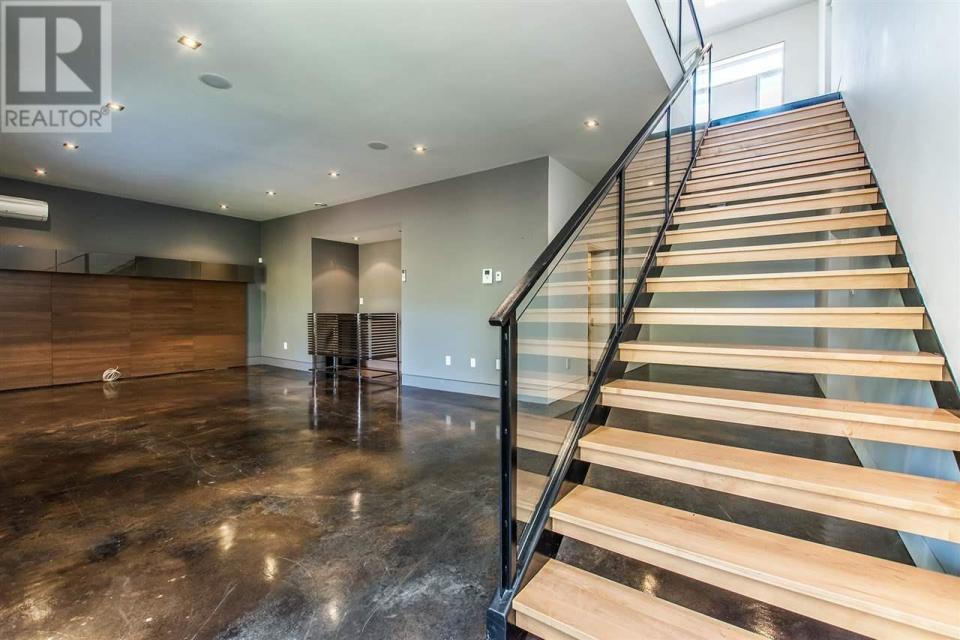 <p><span>7 Palmer Hill Rd., Halifax, N.S.</span><br> Down the custom glass, steel and maple staircase, you’ll find a fully finished basement, including media rom and rec room with bar area.<br> (Photo: Zoocasa) </p>