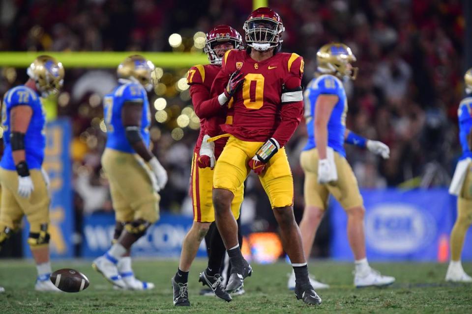 Nov 19, 2022; Pasadena, California, USA; Southern California Trojans defensive end Korey Foreman (0) celebrates after an interception against the UCLA Bruins during the second half at the Rose Bowl. Mandatory Credit: Gary A. Vasquez-USA TODAY Sports