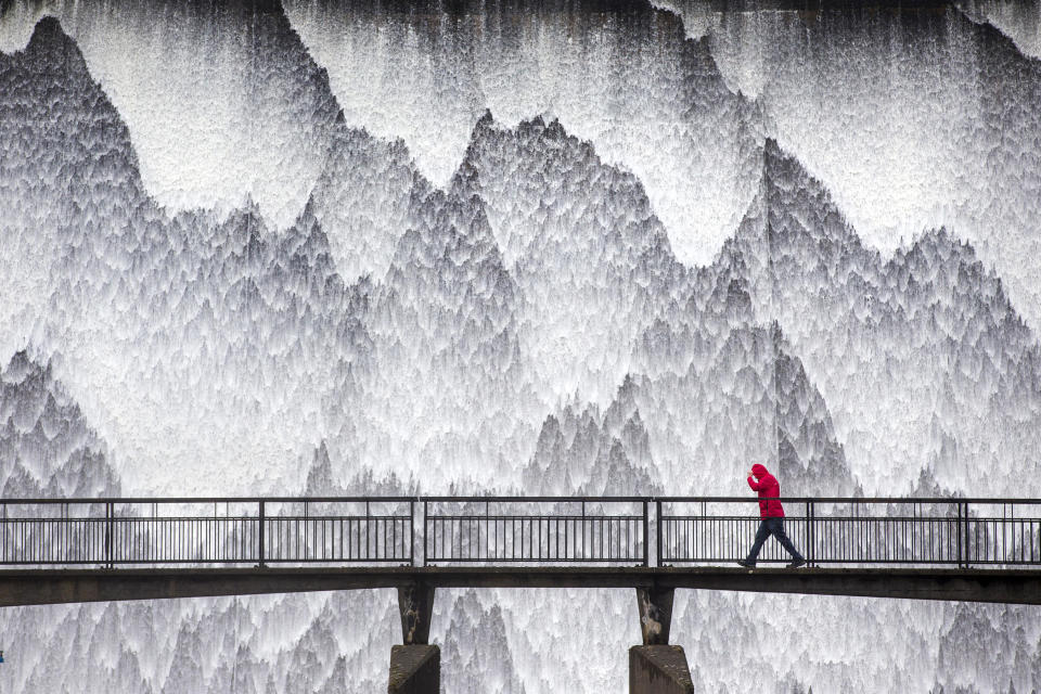 Water cascades down the 21m high dam wall of Wet Sleddale reservoir near Shap in Cumbria