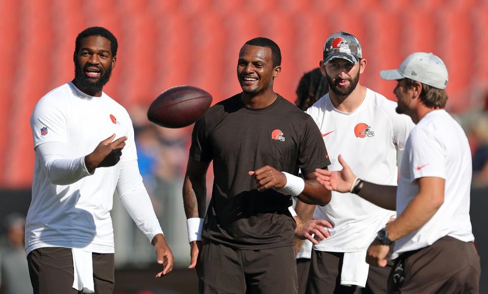 Cleveland Browns quarterbacks Deshaun Watson, center, Jacoby Brissett, left, and Josh Rosen, right, share a laugh before an NFL preseason football game, Saturday, Aug. 27, 2022, in Cleveland, Ohio.