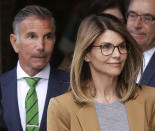 FILE - In this April 3, 2019 file photo, actress Lori Loughlin, front, and husband, clothing designer Mossimo Giannulli, left, depart federal court in Boston after facing charges in a nationwide college admissions bribery scandal. A total of 50 people have been charged, including 33 parents, 10 coaches and college athletics officials, and seven others. (AP Photo/Steven Senne, File)