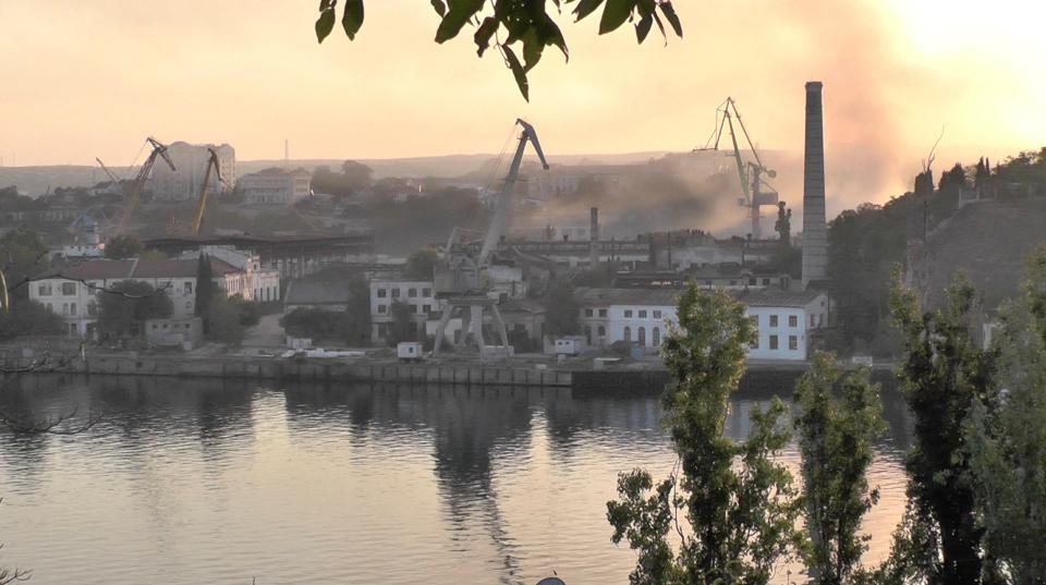 Smoke rises from the shipyard that was reportedly hit by Ukrainian missile attack in Sevastopol, Crimea, in this still image from video taken September 13, 2023.