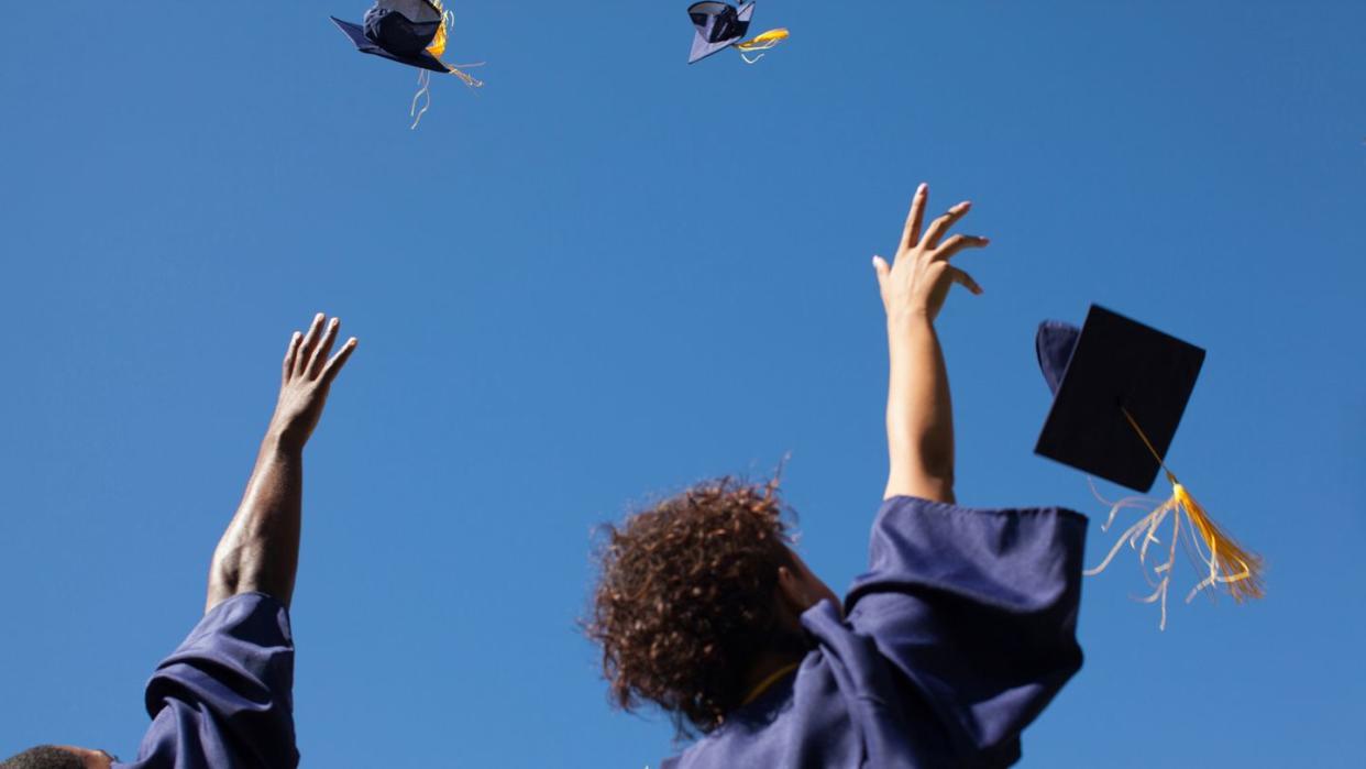 grads throwing their caps in the air