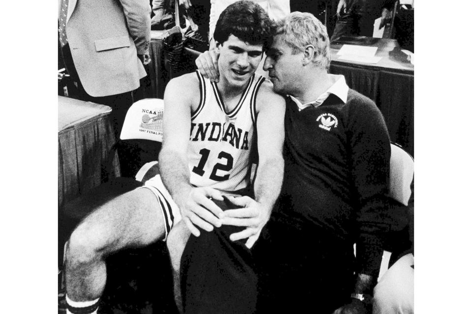 FILE - Indiana coach Bob Knight and player Steve Alford share a moment on the sidelines after Indiana won the NCAA men's basketball tournament hampionship in New Orleans, March 30, 1987. Knight, the brilliant and combustible coach who won three NCAA titles at Indiana and for years was the scowling face of college basketball, has died. He was 83. Knight's family made the announcement on social media on Wednesday night, Nov. 1, 2023, saying he was surrounded by family members at his home in Bloomington, Ind. (AP Photo/Bob Jordan, File)