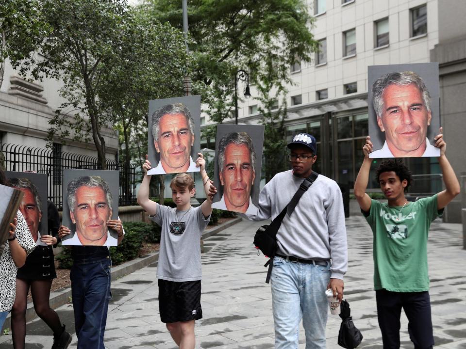 Demonstrators hold photos aloft protesting Jeffrey Epstein in New York.JPG