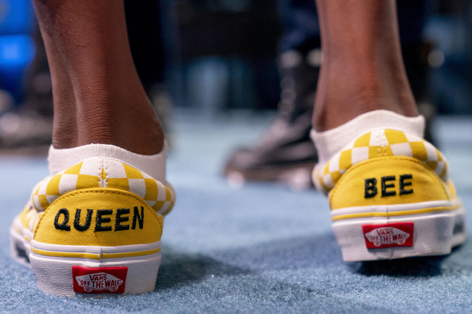 Vivinsha Veduru, 11, from Keller, Texas, wears sneakers that read "Queen Bee" as she competes during the Scripps National Spelling Bee, Wednesday, June 1, 2022, in Oxon Hill, Md. (AP Photo/Andrew Harnik)