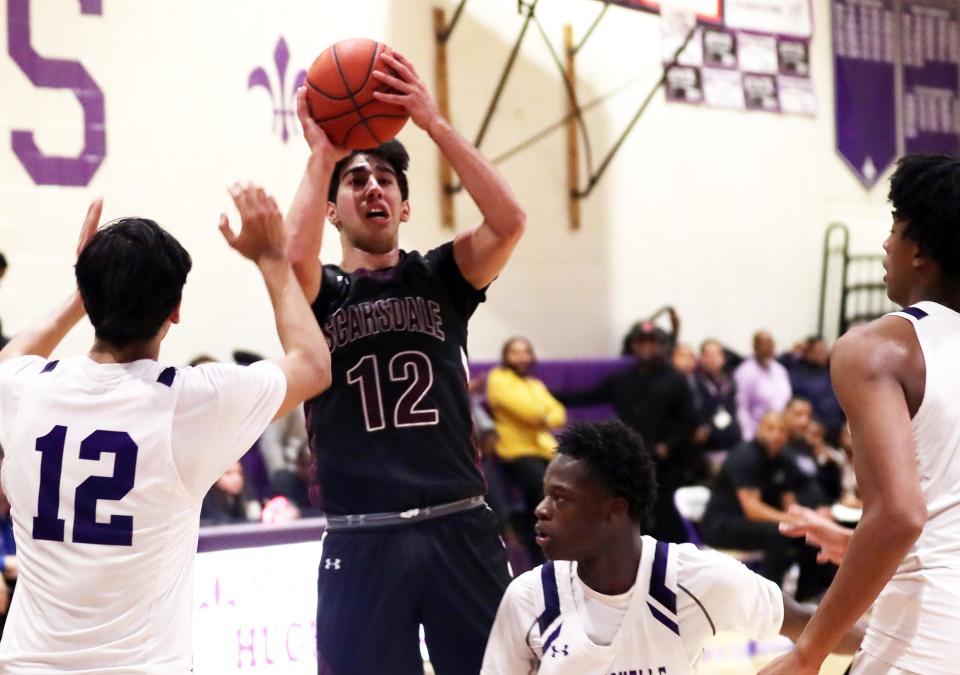 Scarsdale's Carlos Rodriguez (12) puts up a shot against New Rochelle during boys basketball action at New Rochelle High School Jan. 3, 2024. New Rochelle won the game 63-49.