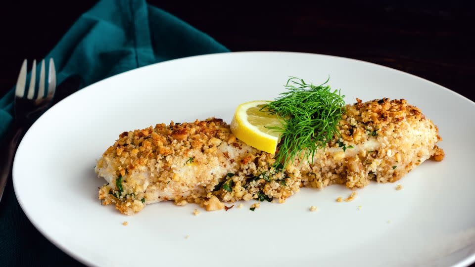 Nuts can be used to bread fish or chicken. Here is a baked white fish fillet garnished with fresh dill and a slice of lemon. - Candice Bell/iStockphoto/Getty Images