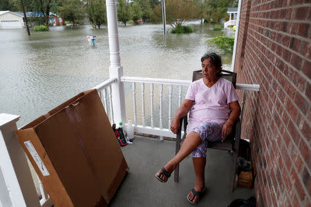 After just rebuilding her home from the floods of 2016, Willie Allen watches the water rise from her porch during Tropical Storm Florence in Lumberton, North Carolina, U.S. September 16, 2018. REUTERS/Randall Hill