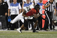 Central Florida defensive back Dyllon Lester (18) attempts to tackle Louisville tight end Marshon Ford (83) during the second half of an NCAA college football game in Louisville, Ky., Friday, Sept. 17, 2021. (AP Photo/Timothy D. Easley)