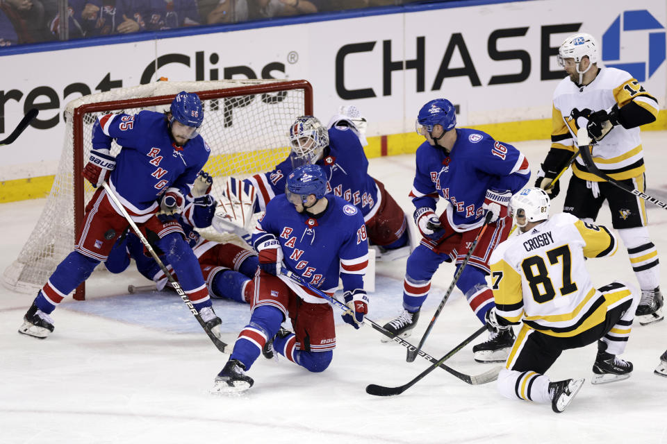 New York Rangers defenseman Ryan Lindgren (55) deflects a shot by Pittsburgh Penguins center Sidney Crosby (87) during the second overtime of Game 1 of an NHL hockey Stanley Cup first-round playoff series Tuesday, May 3, 2022, in New York. (AP Photo/Adam Hunger)