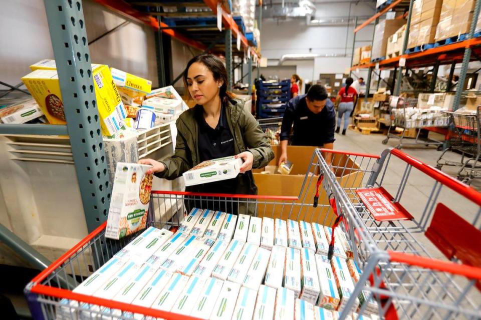 Bank of America employees volunteered to package donations at the SLO Food Bank’s 20,000-square-foot San Luis Obispo warehouse in 2021. Priscilla Cabigas, a financial center manager for Bank of America in Paso Robles, sorts boxes of cereal in the warehouse.