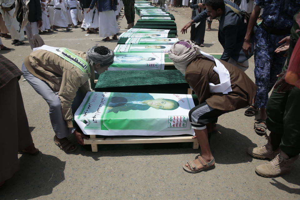 Yemeni people carry the coffin of a victim of a Saudi-led airstrike, in Saada, Yemen, Monday, Aug. 13, 2018. Yemen's shiite rebels are backing a United Nations' call for an investigation into the airstrike in the country's north that killed dozens of people including many children. (AP Photo/Hani Mohammed)