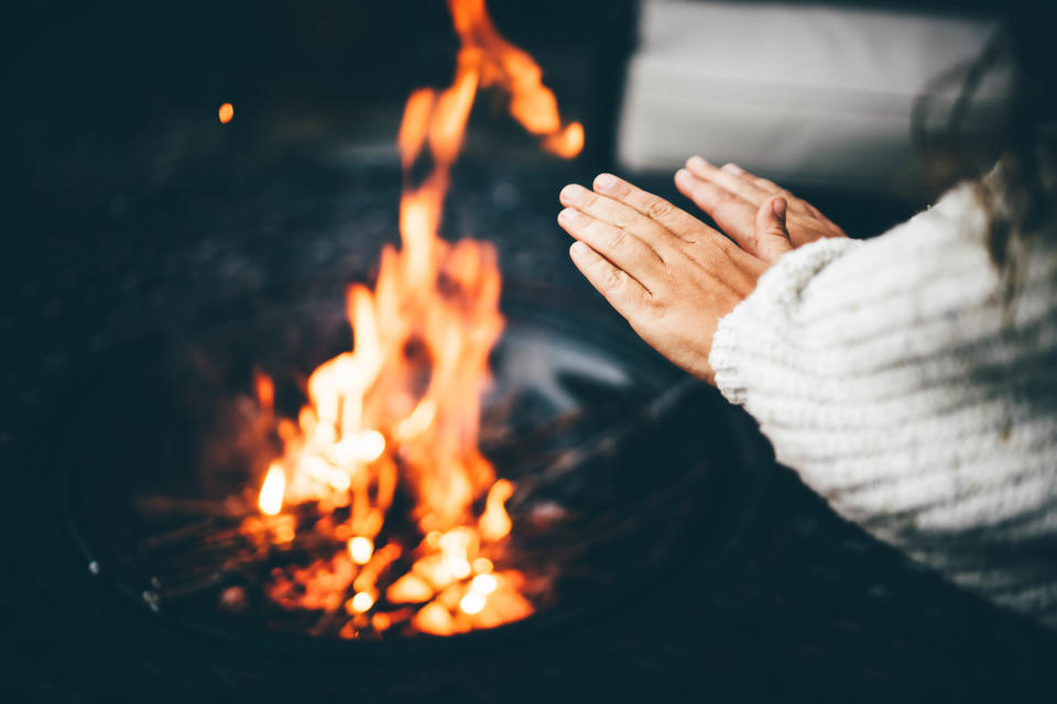 Warming hands by fire