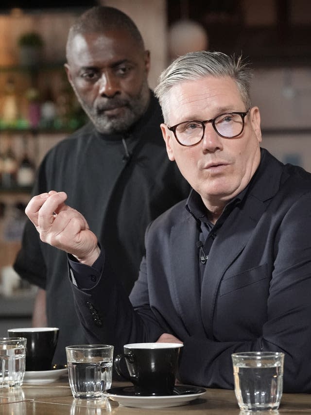 Sir Keir Starmer with Idris Elba standing behind him