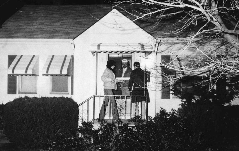 Investigators swarm the residence of bookmaker Frank "Bolo" Dovishaw after he was found dead in his basement in an execution-style slaying on Jan. 4, 1983. He lived in the 1600 block of West 21st Street. Police said he was killed on Jan. 3, 1983.