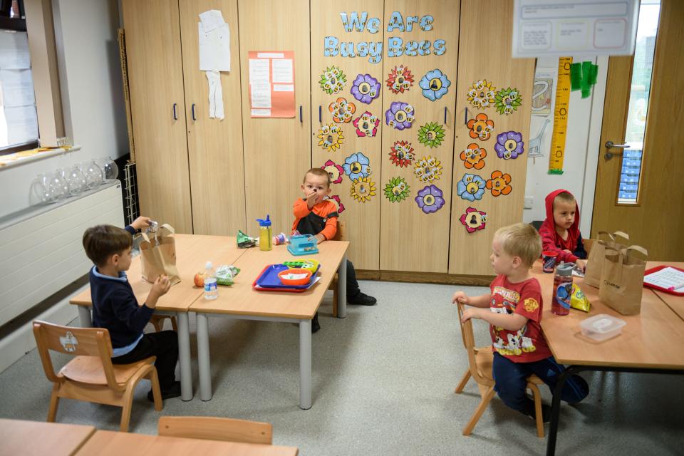 Nursery children have their lunch whilst sitting apart in order to minimise the risk of passing on Coronavirus at Willowpark Primary Academy in Oldham, north-west England on June 18, 2020, as primary schools to recommence education for Reception, Years 1 and Year 6 classes, alongside priority groups. (Photo by OLI SCARFF / AFP) (Photo by OLI SCARFF/AFP via Getty Images)