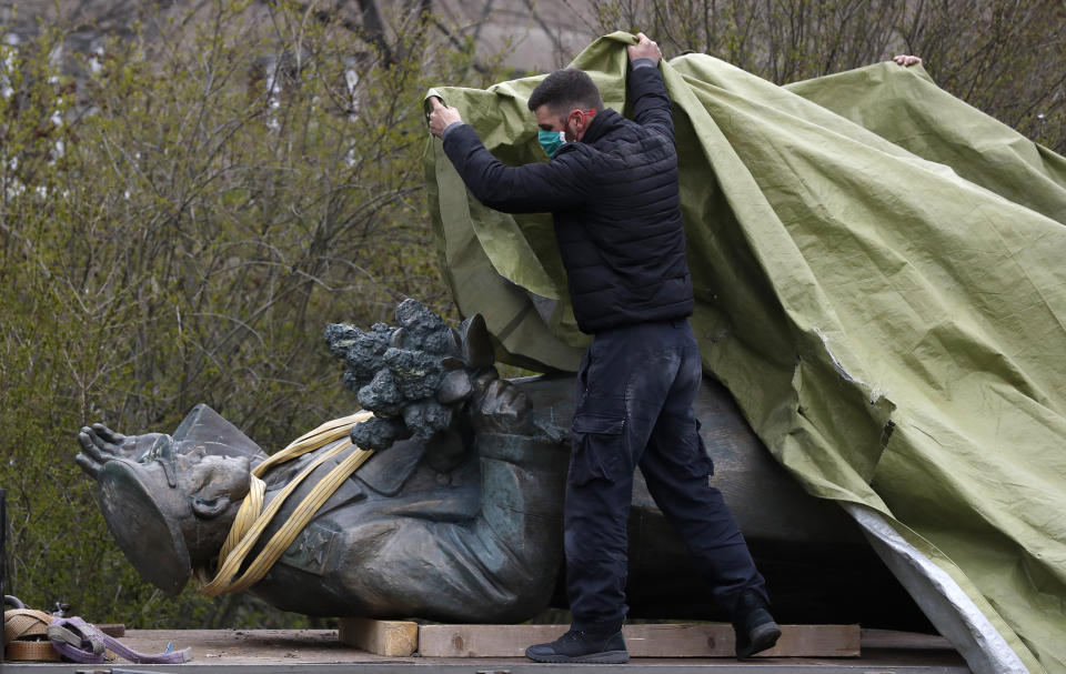 FILE - In this file photo taken on Friday, April 3, 2020, a worker covers the statue of a Soviet World War II commander Marshall Ivan Stepanovic Konev for removal from its site in Prague, Czech Republic. Relations between the Czech Republic and Russia have taken a turn for the worse in a series of disputes over the interpretation of historical events. Three Prague politicians whose recent actions upset Russia have been placed under police protection amid a media report that Russian intelligence services have been plotting to poison them with the deadly toxin ricin. Russia has opened a criminal investigation into Prague's removal of a war memorial to a World War II hero, among other actions that have tested diplomatic ties. (AP Photo/Petr David Josek/File)