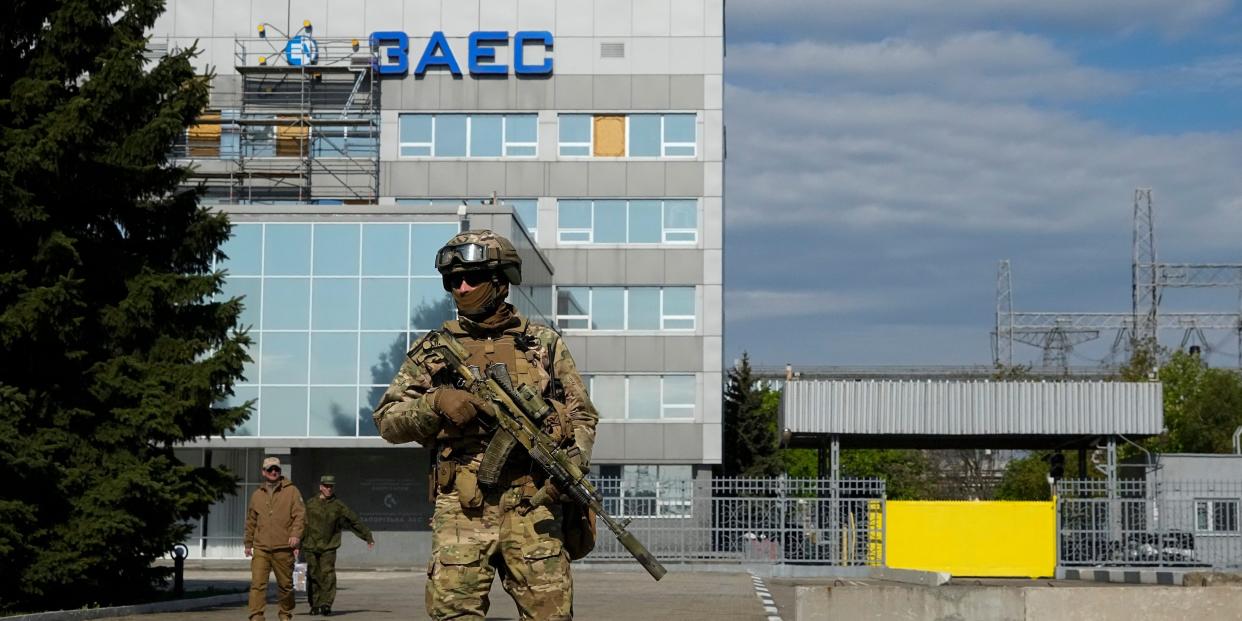 A Russian serviceman stands guard in an area of the Zaporizhzhia Nuclear Power Station in territory under Russian military control, southeastern Ukraine, on May 1, 2022.