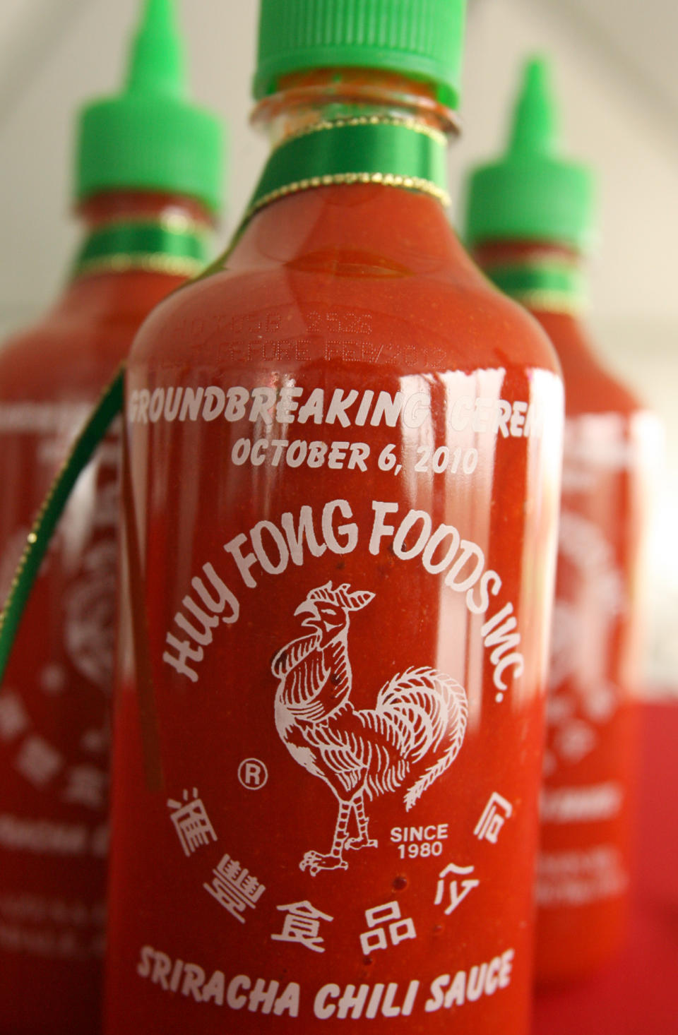 This Oct. 6, 2010 photo shows bottles of Huy Fong Foods Inc.'s Sriracha chili sauce during a groundbreaking ceremony for the company's Irwindale, Calif. factory. The city of Irwindale on Monday, Oct. 28, 2013 filed a lawsuit in Los Angeles Superior Court asking a judge to stop production at the Irwindale factory, claiming the chili odor emanating from the plant is a public nuisance. (AP Photo/San Gabriel Valley Tribune, Leo Jarzomb) MAGS OUT; NO SALES; MANDATORY CREDIT