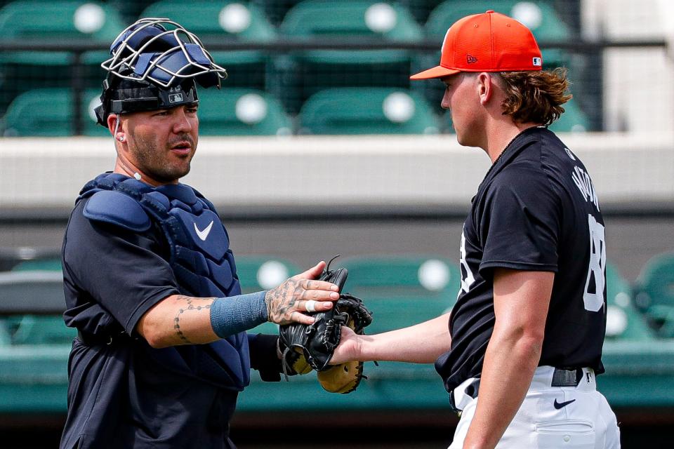 Detroit Tigers catcher Donny Sands shakes hands with pitcher Tyler Holton after live batting practice during spring training at TigerTown in Lakeland, Fla. on Friday, Feb. 23, 2024.