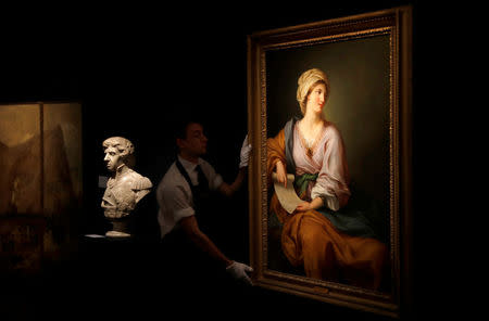 A member of Sotheby's staff poses for a photograph with a portrait of Emma Hamilton which forms part of the sale of items celebrating Nelson's Legend, in London, Britain January 11, 2018. REUTERS/Peter Nicholls