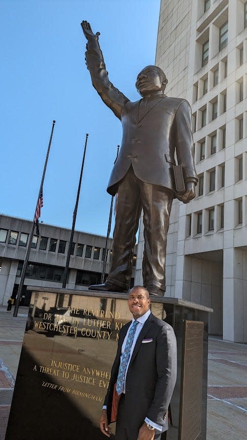 William O. Wagstaff III, a candidate for Westchester County district attorney, stands by the statue of the Rev. Martin Luther King by the Richard Daronco Westchester County Courthouse on April 23, 2024.