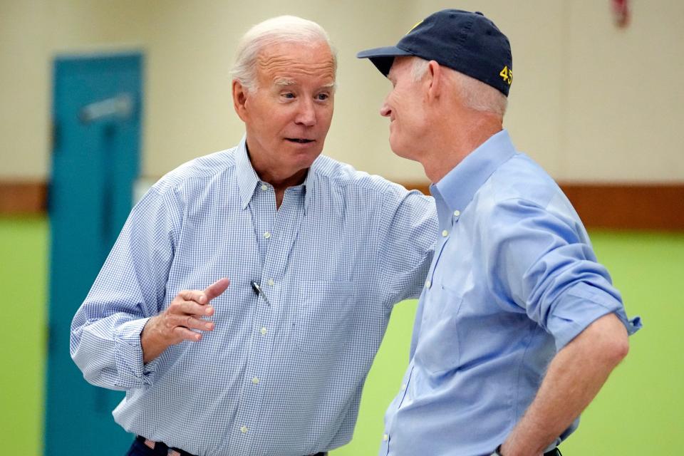 President Joe Biden talks with Sen. Rick Scott, R-Fla., during a briefing about response and recovery efforts to the aftermath of Hurricane Idalia at Suwannee Pineview Elementary School, Saturday, Sept. 2, 2023, in Live Oak, Fla.