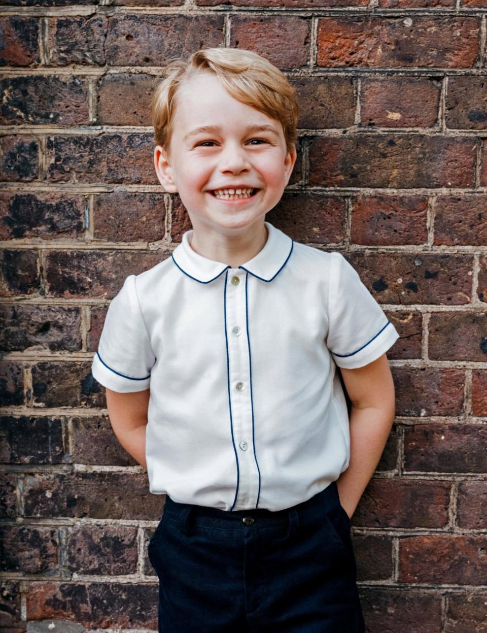 Birthday smiles: Prince George beams at the camera (REUTERS)