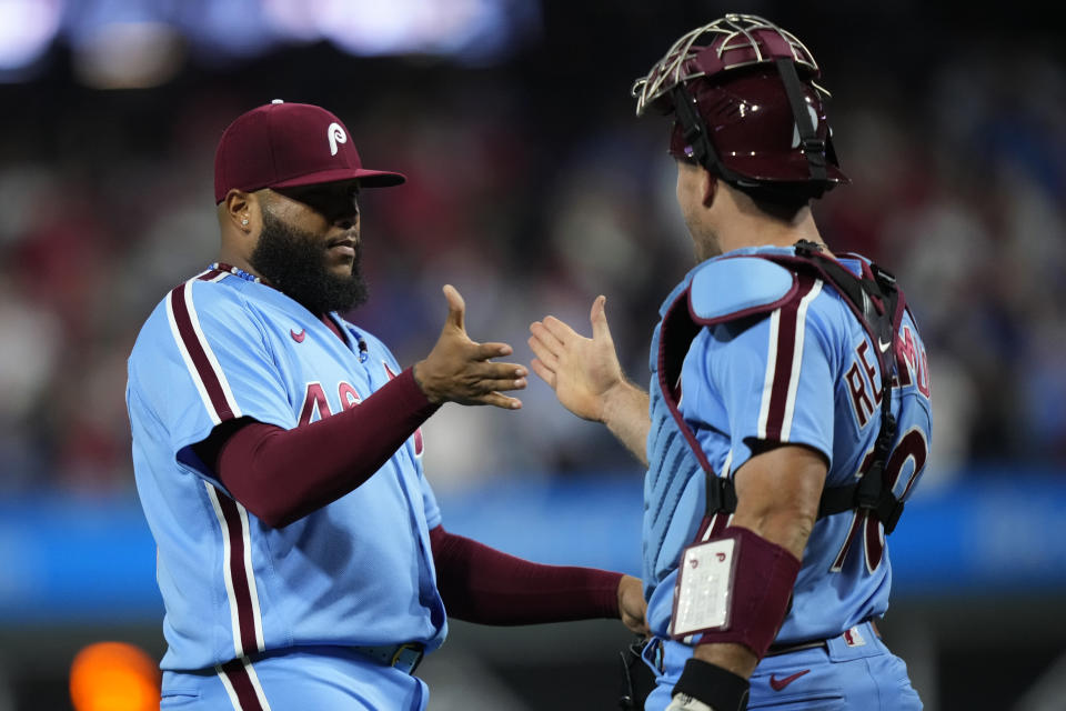 Philadelphia Phillies' Jose Alvarado, left, and J.T. Realmuto celebrate after the Phillies won a baseball game against the New York Mets, Thursday, Sept. 21, 2023, in Philadelphia. (AP Photo/Matt Slocum)