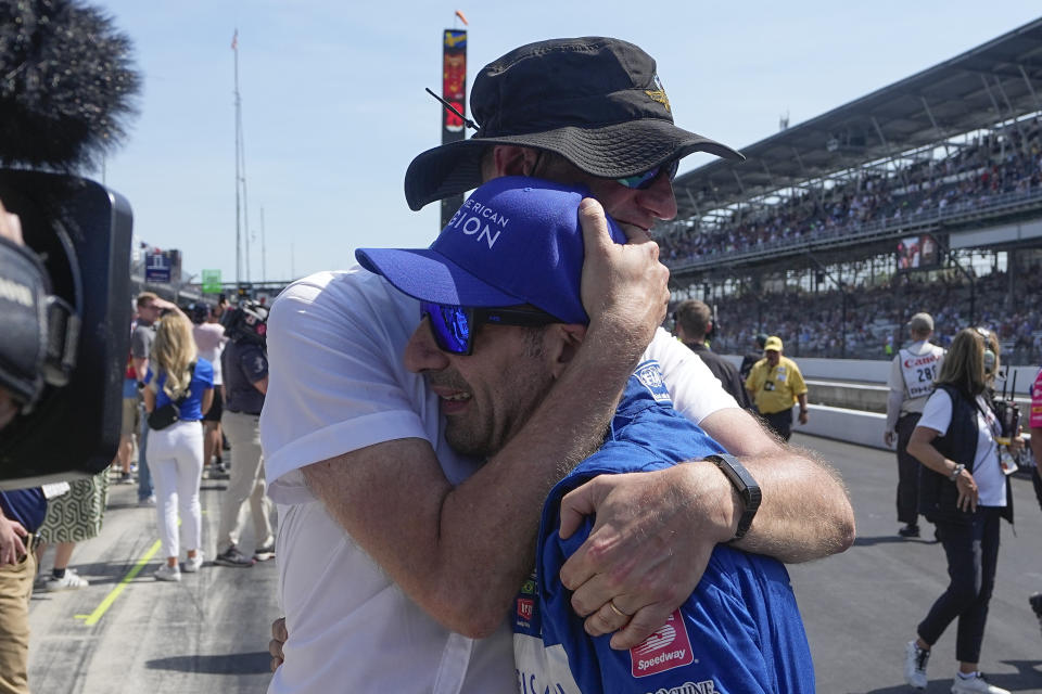 Tony Kanaan, front, of Brazil, gets a hug from an engineer following the Indianapolis 500 auto race at Indianapolis Motor Speedway, Sunday, May 29, 2022, in Indianapolis. (AP Photo/Darron Cummings)