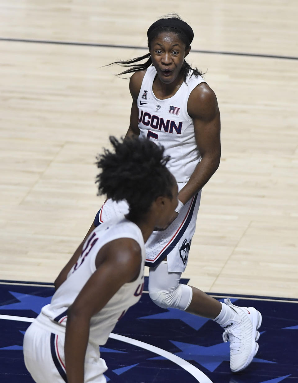 Connecticut's Crystal Dangerfield, top, reacts toward teammate Christyn Williams during the second half of an NCAA college basketball game in the American Athletic Conference tournament quarterfinals, Saturday, March 9, 2019, at Mohegan Sun Arena in Uncasville, Conn. (AP Photo/Jessica Hill)